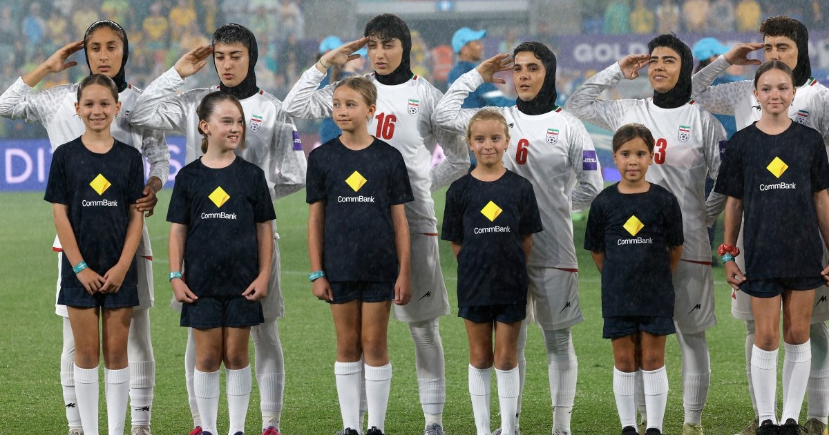 Iranian Women's Football Team Raises Hands in Salute During Anthem as Crowd Boos and Waves Pre-1979 Flag Amid Violence in Iran