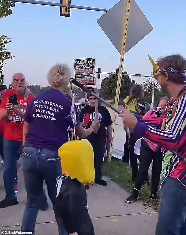 Protester wearing 'Make America Kind Again' Shirt Smashes Trump Pinata With Pipe