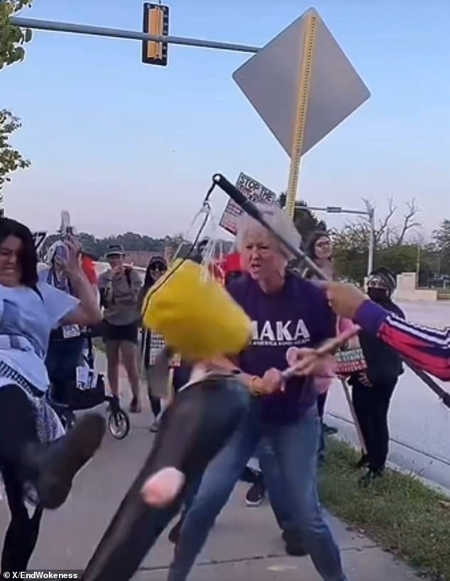 Protester wearing 'Make America Kind Again' Shirt Smashes Trump Pinata With Pipe