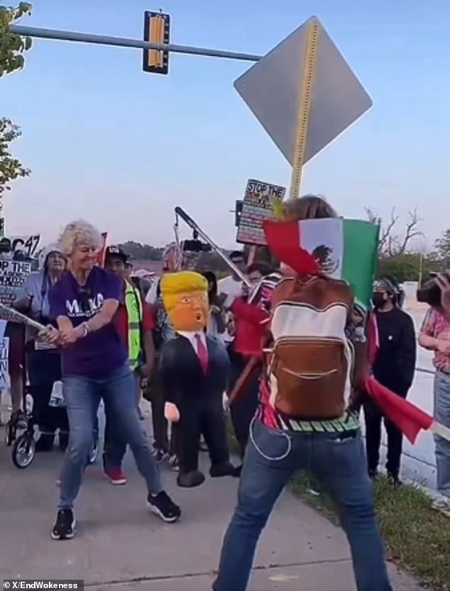 Protester wearing 'Make America Kind Again' Shirt Smashes Trump Pinata With Pipe