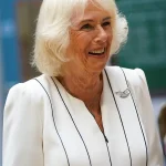 Queen Camilla Braves the Rain in Elegantly Monochrome Ensemble as Royal Colonel at New Normandy Barracks