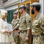 Queen Camilla Braves the Rain in Elegantly Monochrome Ensemble as Royal Colonel at New Normandy Barracks