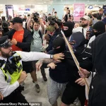Violent Confrontation Breaks Out Between Anti-Migrant Protesters and Police at Canary Wharf